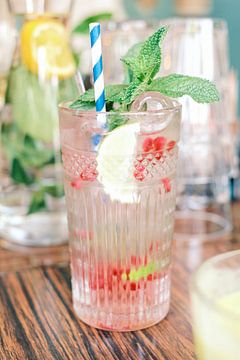 Glass with lemonade and fresh red fruit