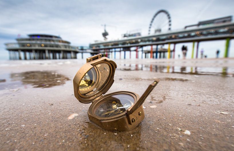A sea compass on the beach in Scheveningen. The Pier is visible in the background. by Claudio Duarte