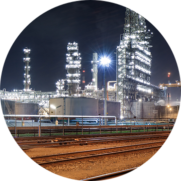 Trein rails en verlichte petrochemische industrie 's nachts van Tony Vingerhoets