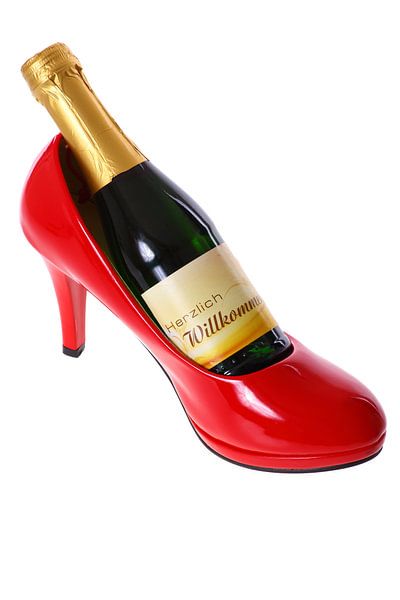 Champagne bottle in a red high heel by Jan Schneckenhaus