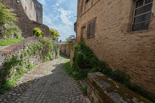 Narrow medieval alley with old stone walls in southern France