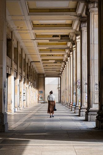 Woman walks through historic gallery