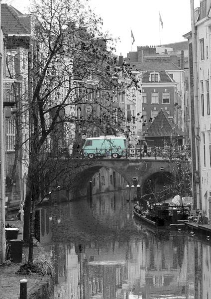Black and white photo of the Oudegracht in Utrecht with green bus by Phillipson Photography