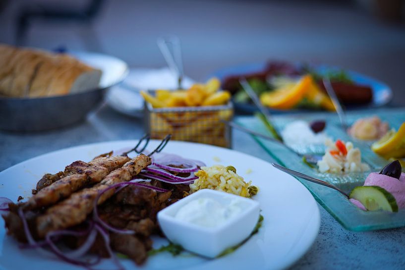 Table full of Greek delicacies by Ken Huysmans