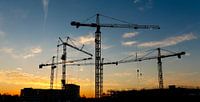 Construction site with cranes at sunrise