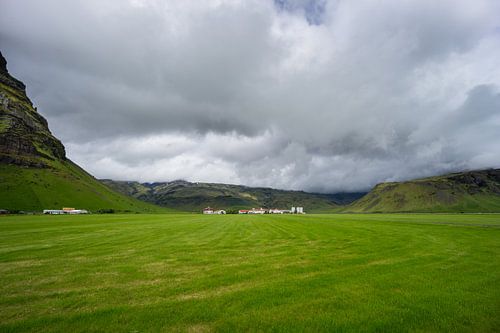 IJsland - Klein dorpje met boerderijen tussen groene bergen
