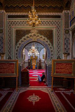 Man sits inside Al Quaraouiyine mosque in Fez