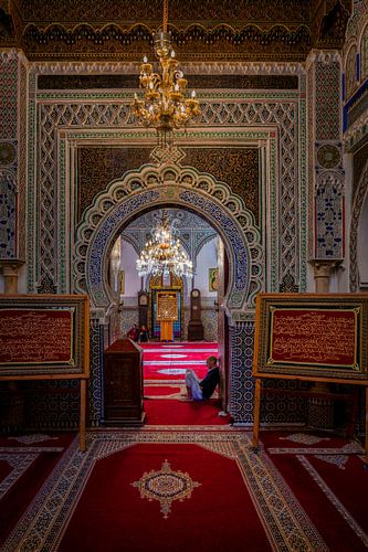 Man sits inside Al Quaraouiyine mosque in Fez