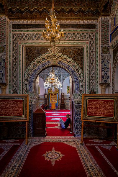 Man sits inside Al Quaraouiyine mosque in Fez by Rene Siebring