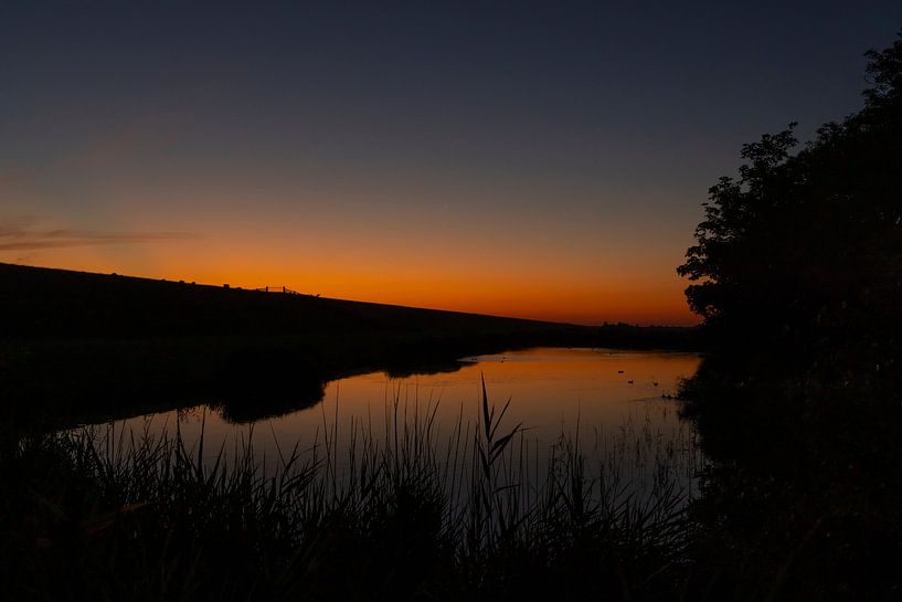 Wadden Sea, sunrise at Paesens Moddergat behind the dike by Gert Hilbink