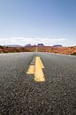 Yellow stripe on asphalt road leading to Monument Valley by Moniek Kuipers thumbnail