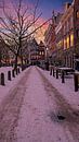 Besneeuwd Amsterdam in de winter bij zonsondergang in Nederland van Eye on You thumbnail