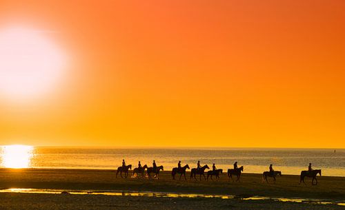 Riding along the beach at sunset