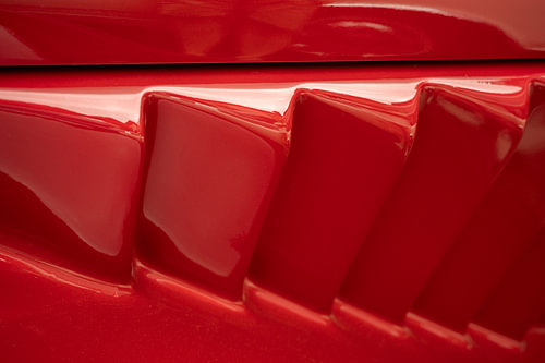 Close-up of a classic car in red. Ferrari-red air intake. by Christa Stroo photography