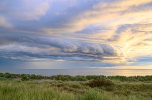Sunrise in the dunes at Texel island with a storm cloud approach