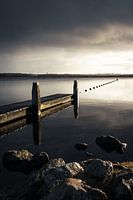 Threatening skies above the jetty at the lake of Oostvoornse