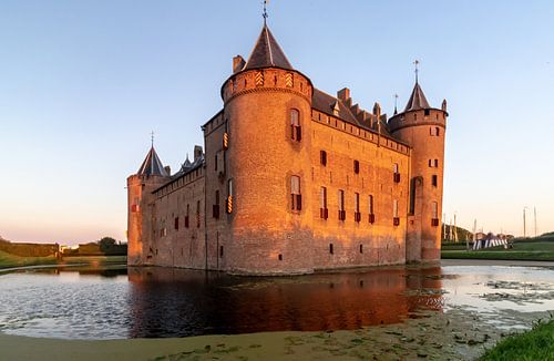 Muiderslot Muiden, avec fossé et soleil couchant.