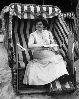 Elegant lady in a beach chair, circa 1900, historical black-and-white photograph, vintage beach poster
