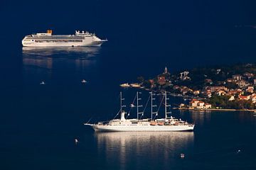 two ships in the bright blue sea and a little girl with red roofs. A beautiful cruise ship in the bl by Michael Semenov