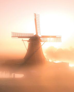 Windmill in morning mist at sunrise by Ewold Kooistra