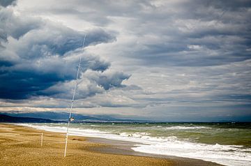 Fishing on the sand beach during thunderstorms and clouds on the Costa del Sol Andalusia Spain by Dieter Walther