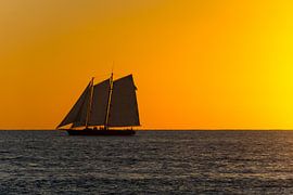 USA, Florida, Burning orange sky after sunset with majestic sailboat by adventure-photos