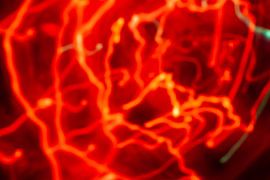 Abstract moving candlelight in red by Mario Verkerk