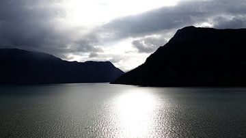 Black mountains and shining water in the Lusterfjord in Norway by Aagje de Jong