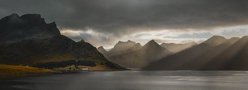 Small white house in the mountains of Norway at sunset