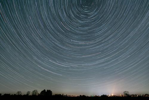 Star trail with skyline of Zutphen by Arnold van Rooij