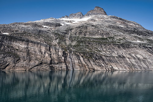 Steep glacial rocks reflected