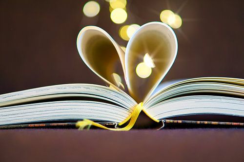 Heart pages in a book with light dots
