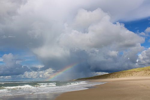 Rainbow and clouds over the sea the beach and dunes