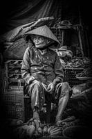 An old woman at a market.