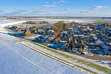 Luchtfoto van het besneeuwde dorp Wierum in Friesland aan een bevroren Waddenzee van Eye on You
