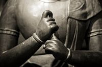 Hands of meditating Buddha statue in sepia