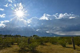 Sun and clouds over Pinaleno Mountains by Bernard van Zwol