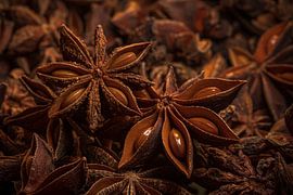 Two star anise on top of star anise in warm colours by Marjolijn van den Berg
