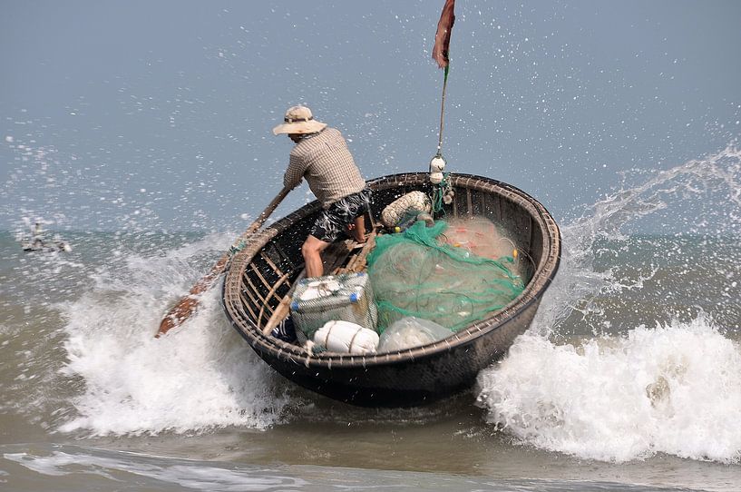 Bamboo basket boat on a beach in Vietnam by Frank Photos