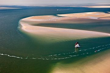 Aerial photo of two boats of the Brown Fleet at low tide in the Wadden Sea by Frans Lemmens