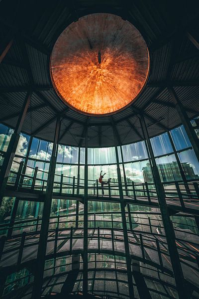 Woman dancing in parking garage by Martijn Van Weeghel