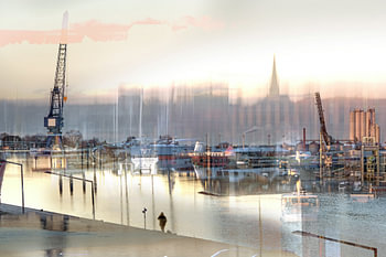 Abstract blurry scene in the port of Lubeck with boats, cranes a