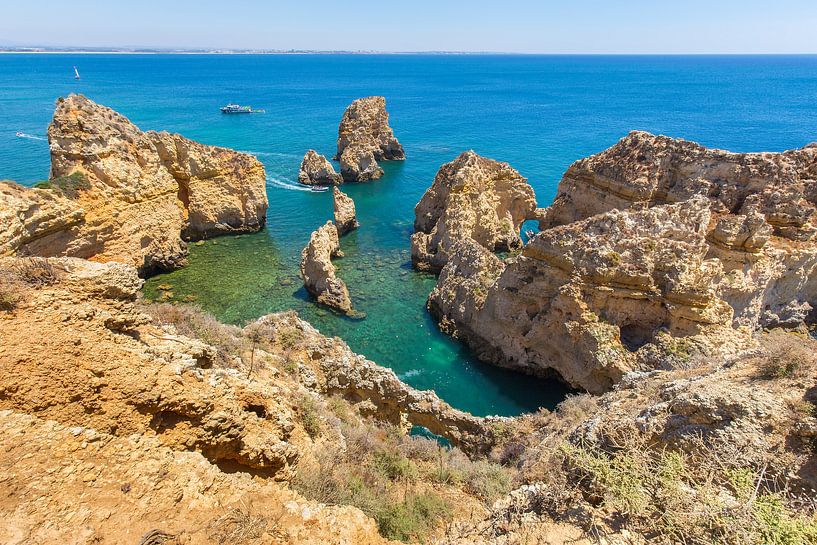 Coast with rocky mountains and blue sea in Algarve Portugal by Ben Schonewille
