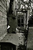 Doors hanging in a frame of a factory building photographed analogously.