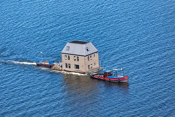 Aerial photo of the transport of a waterville over the IJsselmeer by Frans Lemmens