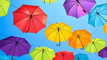 Colourful umbrellas in an old town alley by Heiko Kueverling