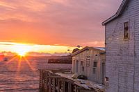 Sunrise over old wooden house at sea in Henningsvaer, Lofoten, Norway