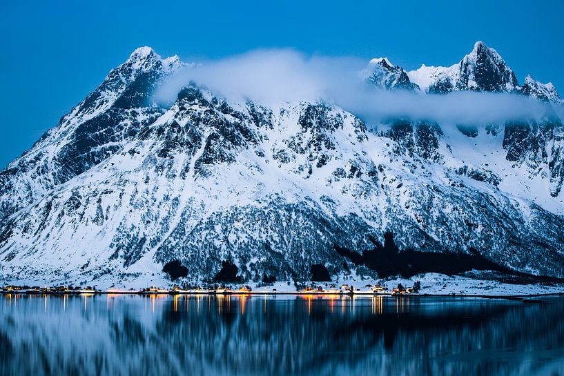 Illuminated village in a fjord by Martijn Smeets
