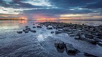 Stones on the Wadden Sea during sunset by Martijn van Dellen thumbnail