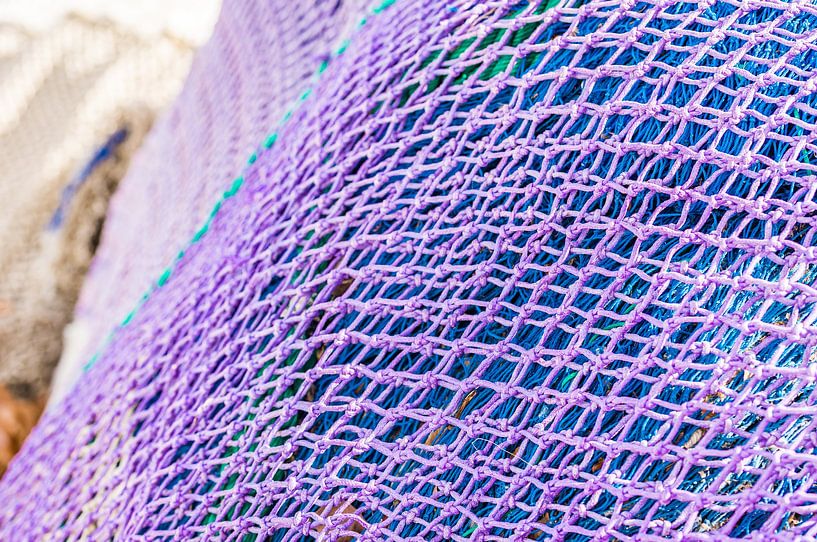 Close-up of purple and blue fish net heap, maritime background texture by Alex Winter